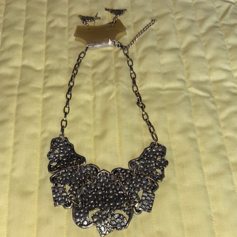 Chic Silvertone PeppledStatement Necklace with matching earrings. $29